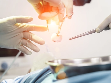 Surgeon Performing Surgery on a Patient with Assistant in an Emergency Surgery Concept