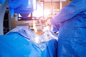 Surgeons perform spinal surgery in an operating room with a  visualization system