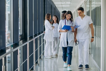 Young Specialist Medical Team Standing in Hospital Corridor