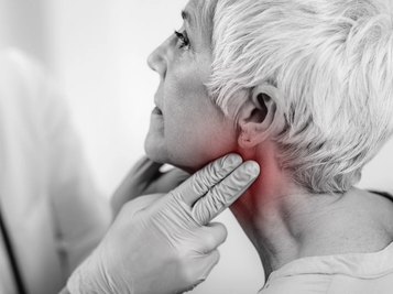 Thyroid Gland Examination by Endocrinology Doctor on Senior Woman at Clinic