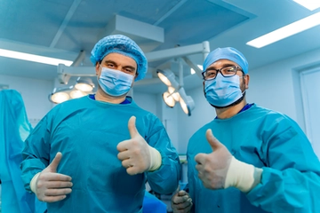 Two Surgeons Giving Thumbs Up in the Surgical Room