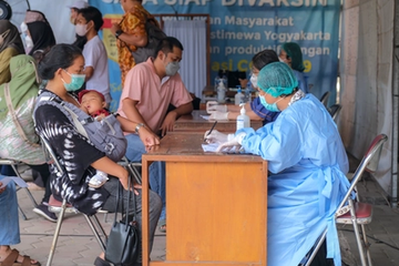 Yogyakarta, Indonesia: Mother Holding Her Baby Undergoing Screening Process